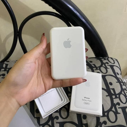 Hand holding an Apple battery pack with packaging in the background
